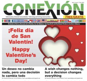 Portada de la edición mensual de la revista Conexión con temática de San Valentín. La portada presenta corazones rojos y blancos de varios tamaños en el lado derecho con el mensaje "¡Feliz día de San Valentín! Happy Valentine's Day!" en el medio. La revista bilingüe incluye texto en español e inglés.