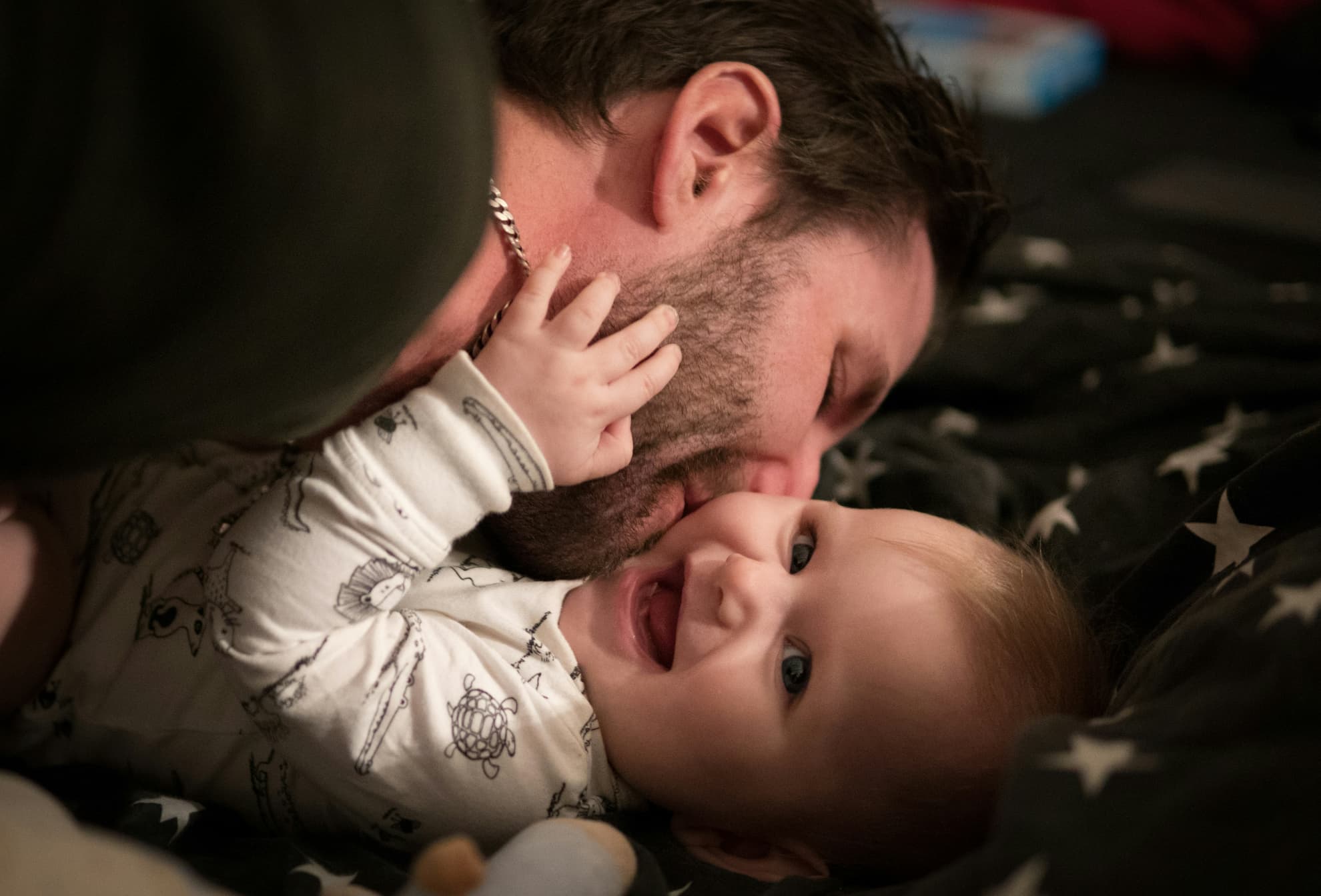 father and child playing in loving embrace