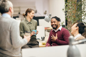 Group of workers chatting with the boss in great spirits