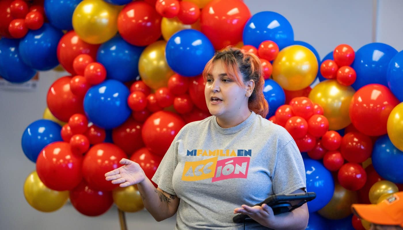 young lady in front of campaign balloons