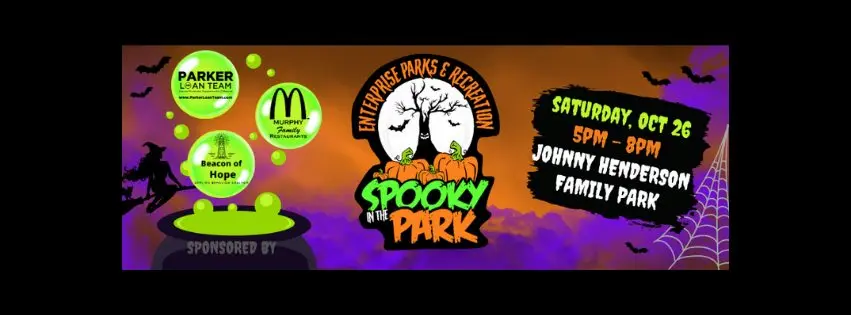 Banner con temática de Halloween para el evento "Spooky in the Park" en el Johnny Henderson Family Park el sábado 26 de octubre, de 5:00 p. m. a 8:00 p. m. El fondo presenta un degradado de color púrpura y naranja con murciélagos, una bruja en una escoba y una telaraña. Los patrocinadores se enumeran a la izquierda.