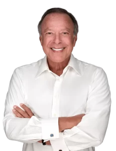 Mike Fernandez in a white shirt with cufflinks stands against a plain background, exuding confidence and simplicity, which doesn't contain enough information for identifying SEO keywords.