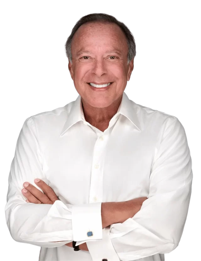 Mike Fernandez in a white shirt with cufflinks stands against a plain background, exuding confidence and simplicity, which doesn't contain enough information for identifying SEO keywords.