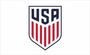 The image portrays the USA Soccer logo, highlighting "USA" in bold navy letters atop a shield. Below, vertical red stripes contrast against a white background, embodying the spirit of the U.S. Soccer Federation and hinting at the exciting soccer future ahead.