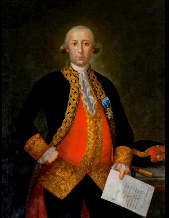 A man in an ornate black and gold coat with a red vest stands holding a paper, representing Hispanic Heroes of the American Revolution. He has powdered hair and stands beside a table with scrolls and a hat on it, against a dark background.